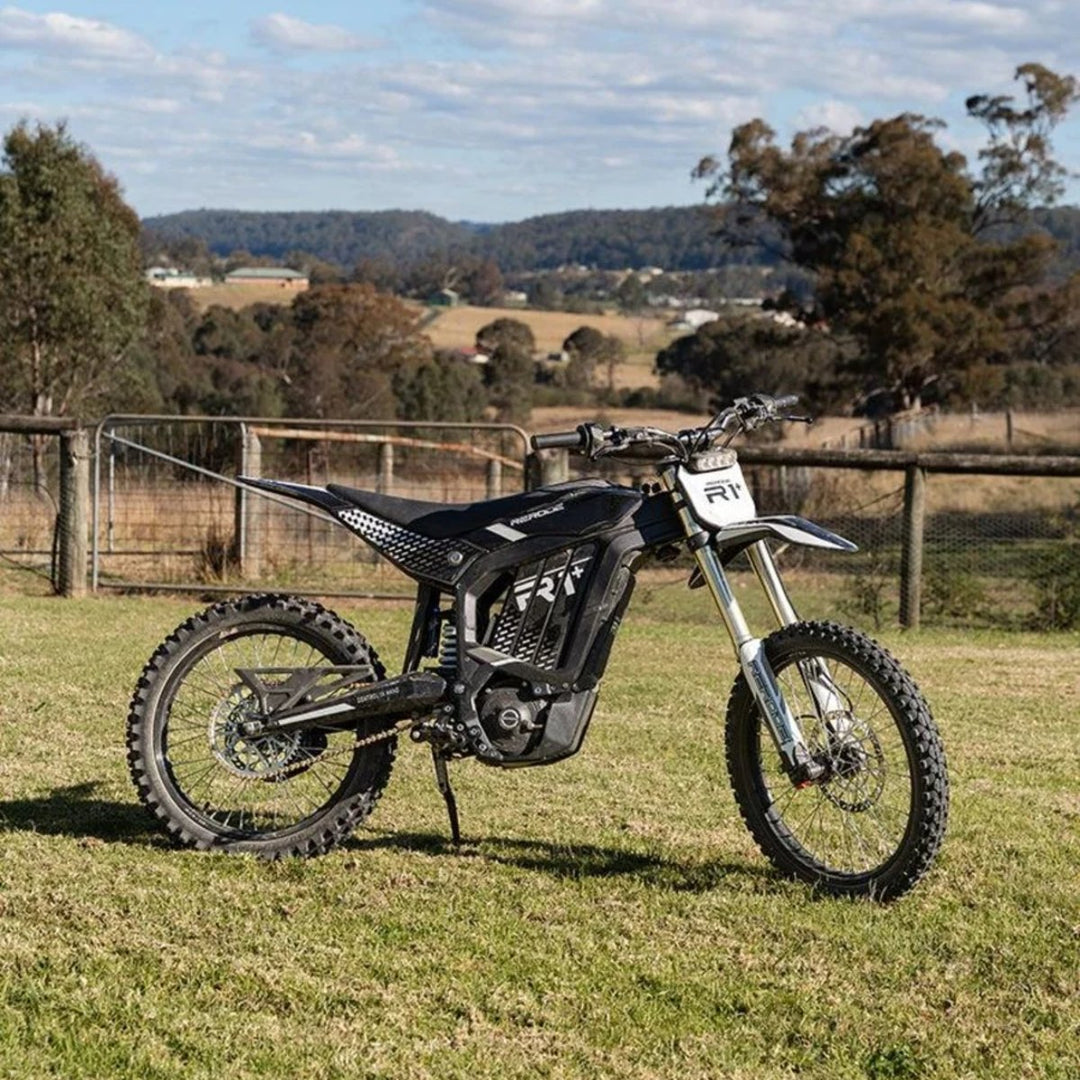 Rerode R1+ electric dirt bike parked on a grassy property