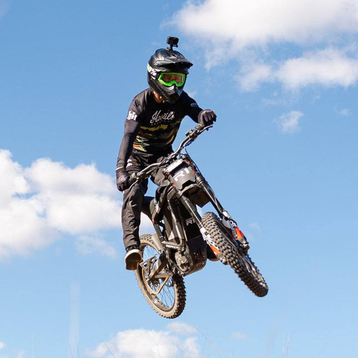 Rider jumping a Rerode R1 electric dirt bike
